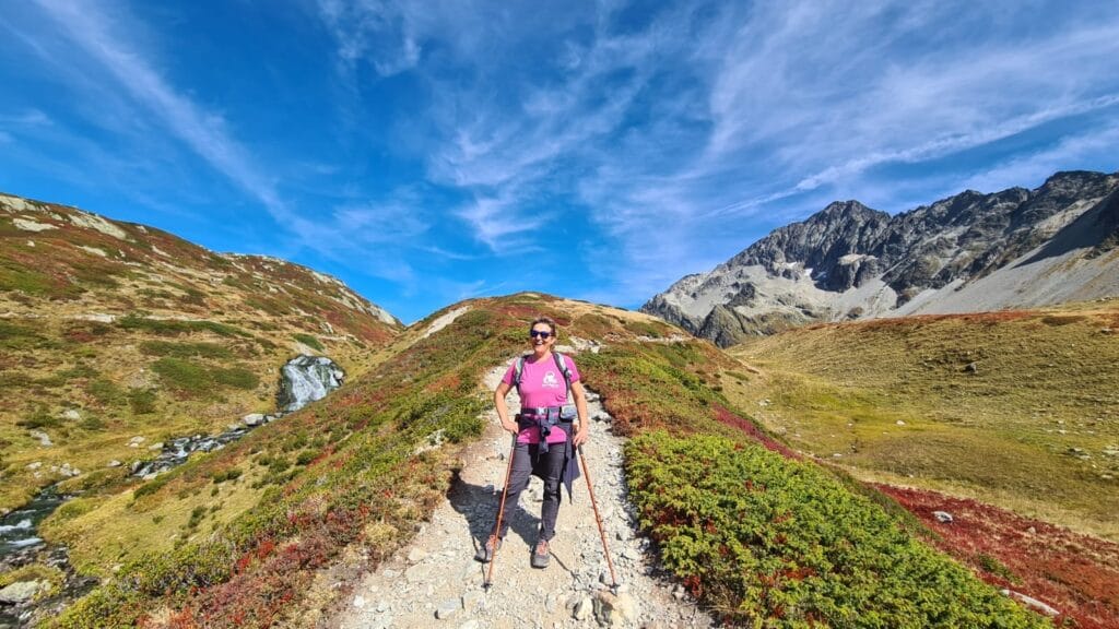 Hiker on a sunny mountain trail.