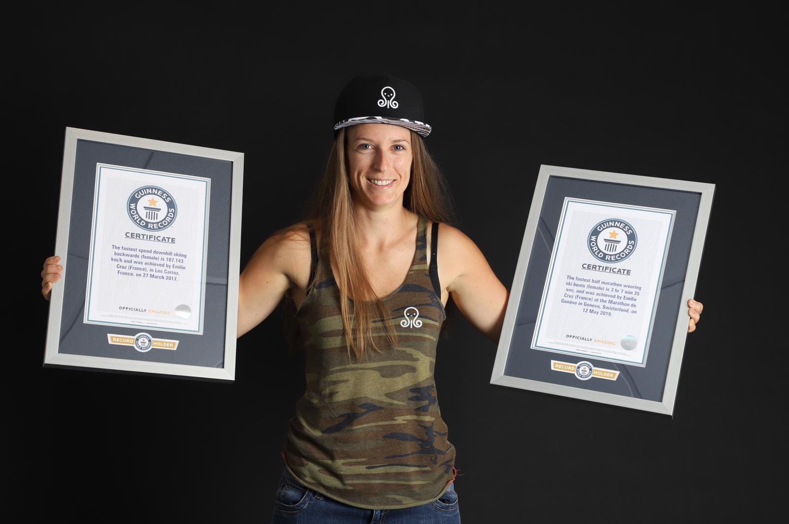 Person with two Guinness World Records certificates.