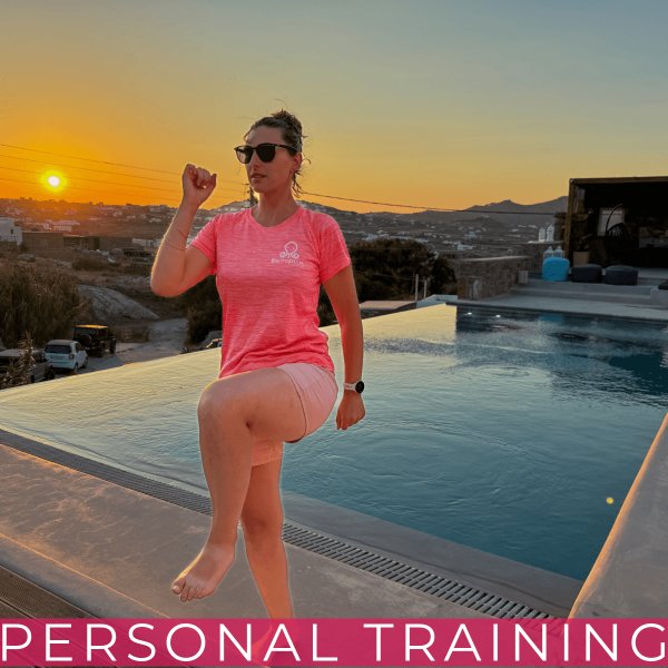 Woman training by a pool at sunset.